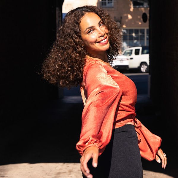 dallia going through tunnel, arm outstretched toward camera